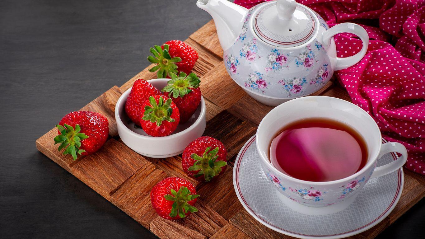 Cup of Strawberry tea with strawberrues on a table